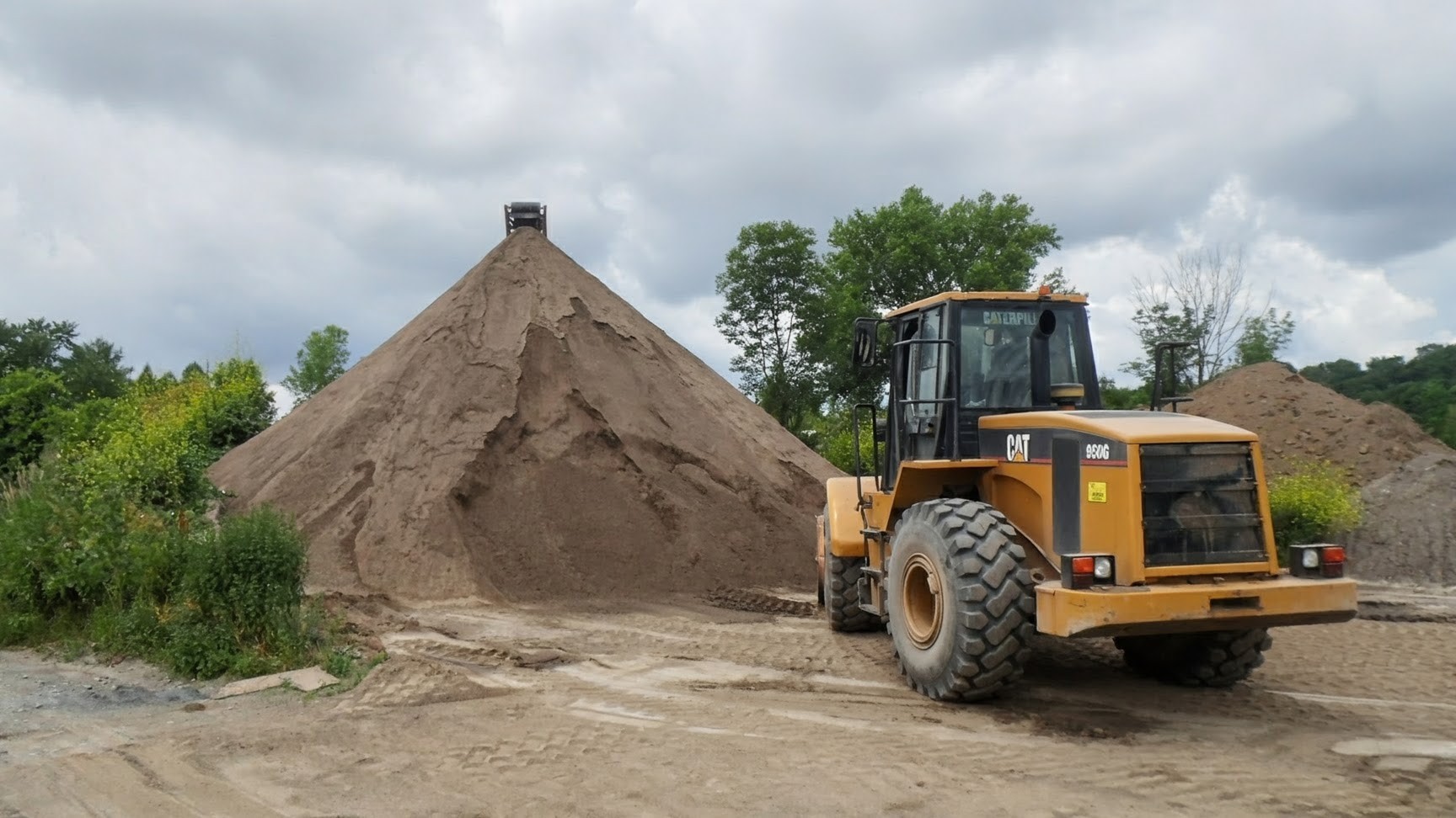 Loader moving topsoil